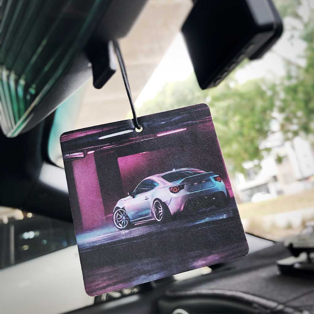 A Toyota 86 air freshener hung in a car