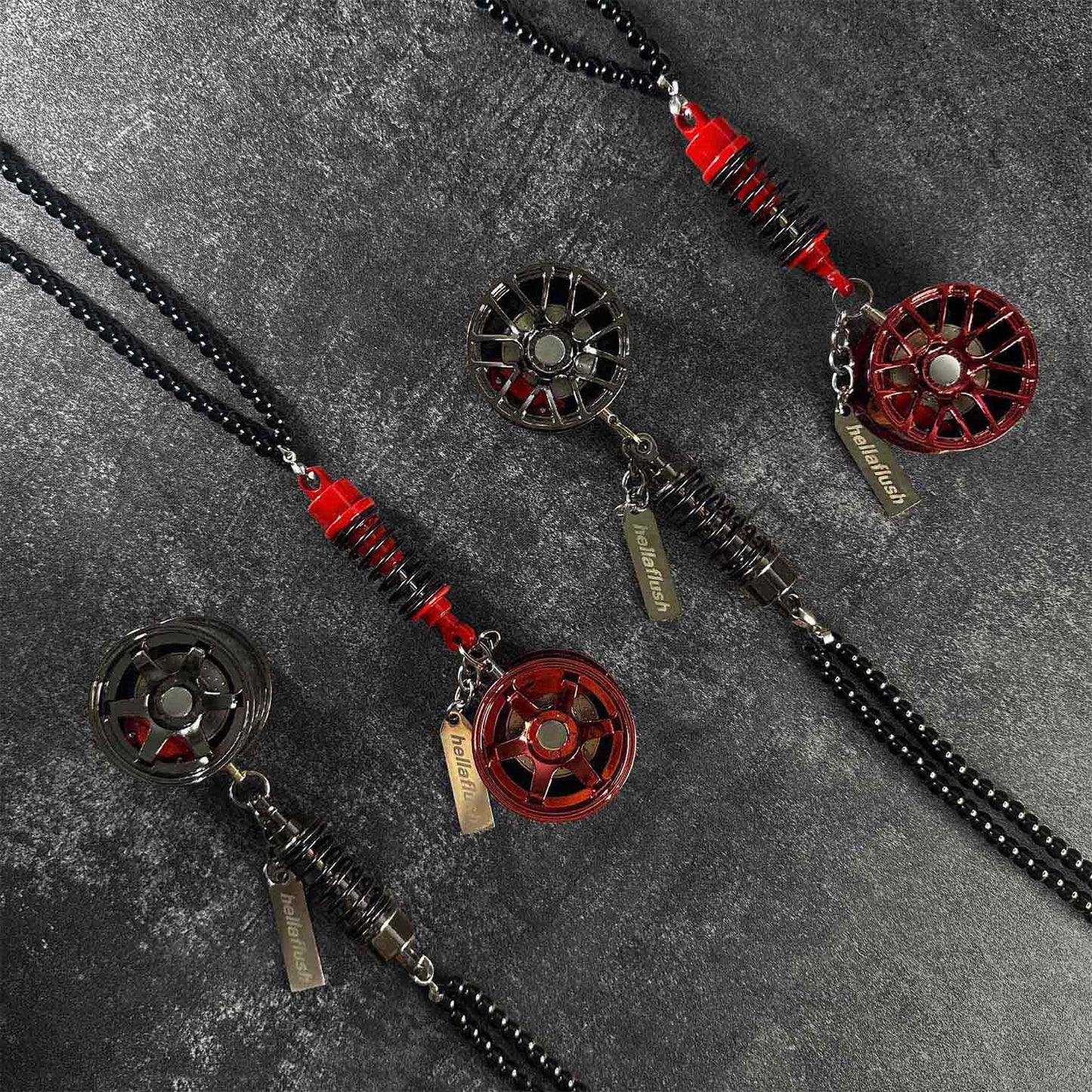 Four wheel decors flat laid on a grey background, two are black and two are red