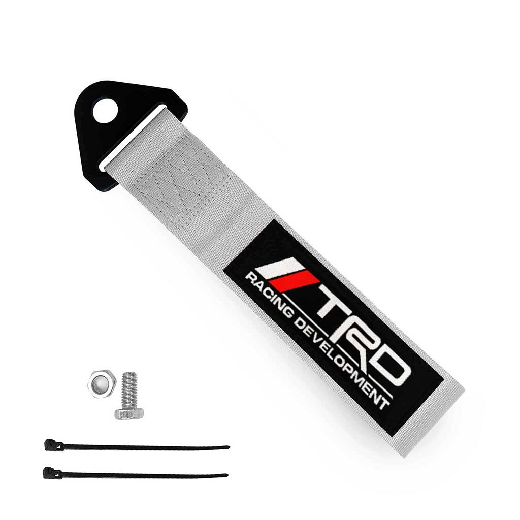 A silver TRD JDM tow strap, a set of bolt and nut, and two zip ties on a white background