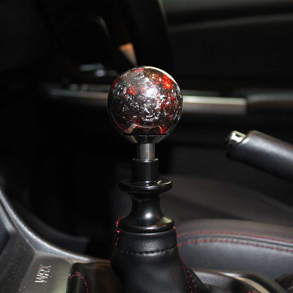 A red spherical carbon fibre shift knob installed in a 6-speed manual 2015 subaru wrx