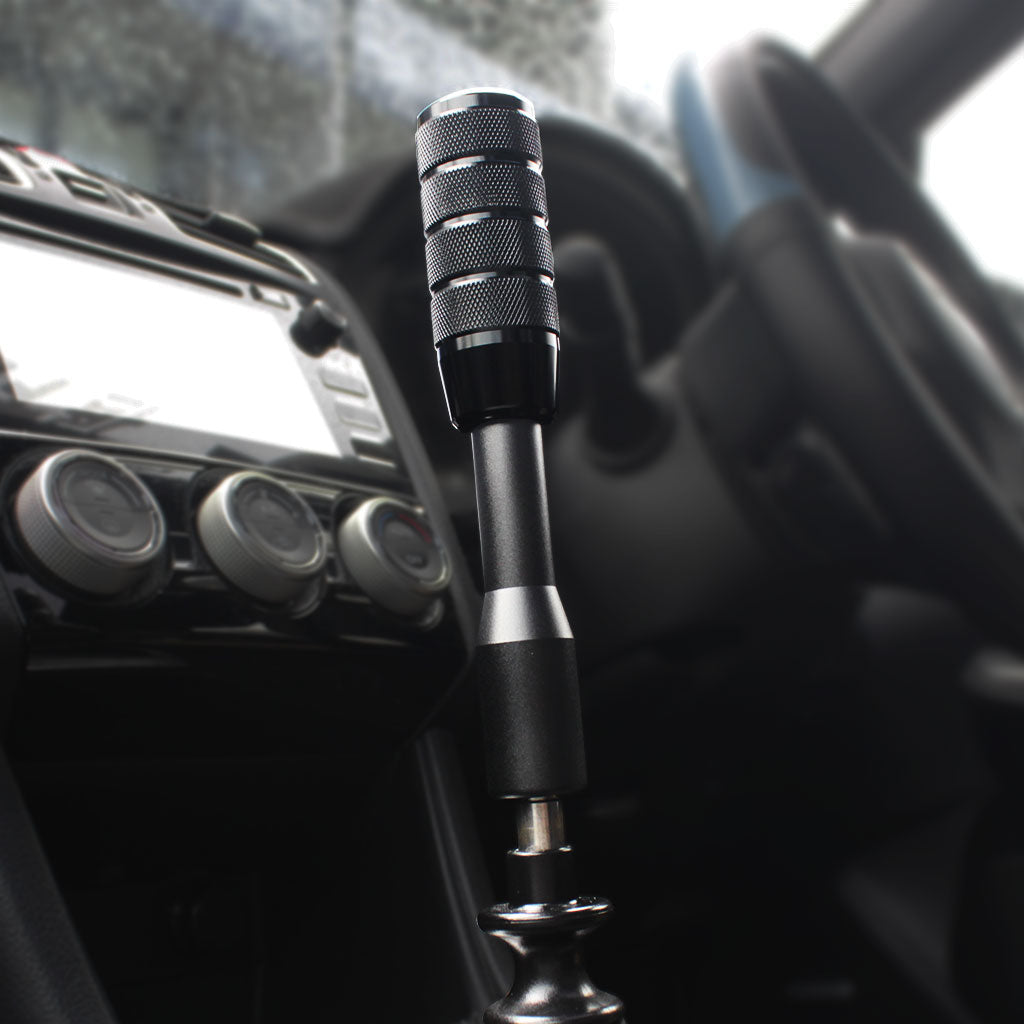 The black Nagao is installed on a manual WRX with a black extension in between, the background bing black and white