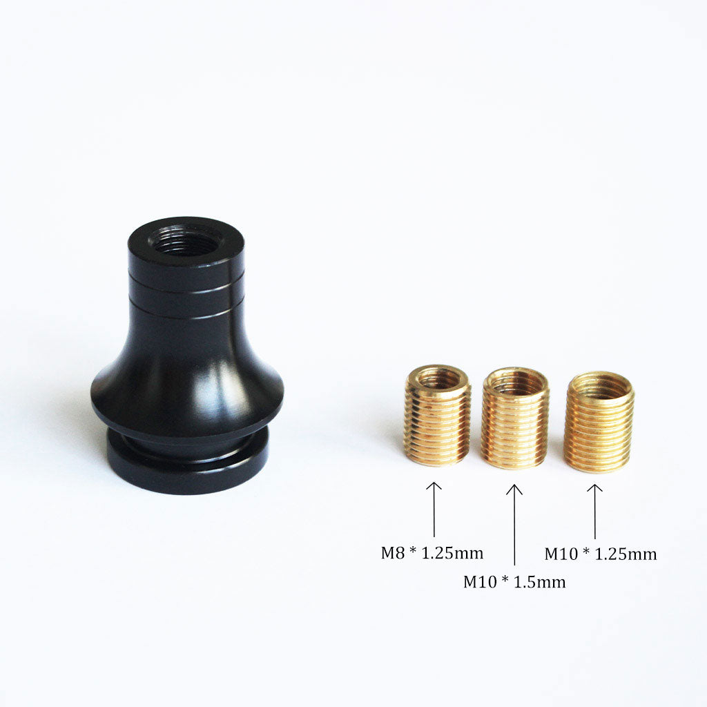 A black threaded boot retainer is standing upright on a white background with three aluminum adapters in different sizes beside it