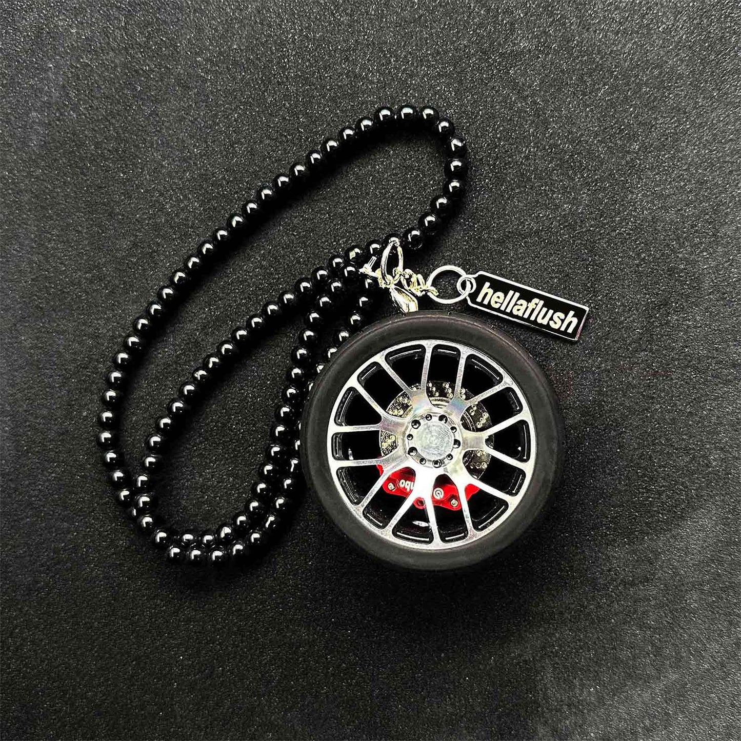 A black BBS wheel air-freshener placed on a black background
