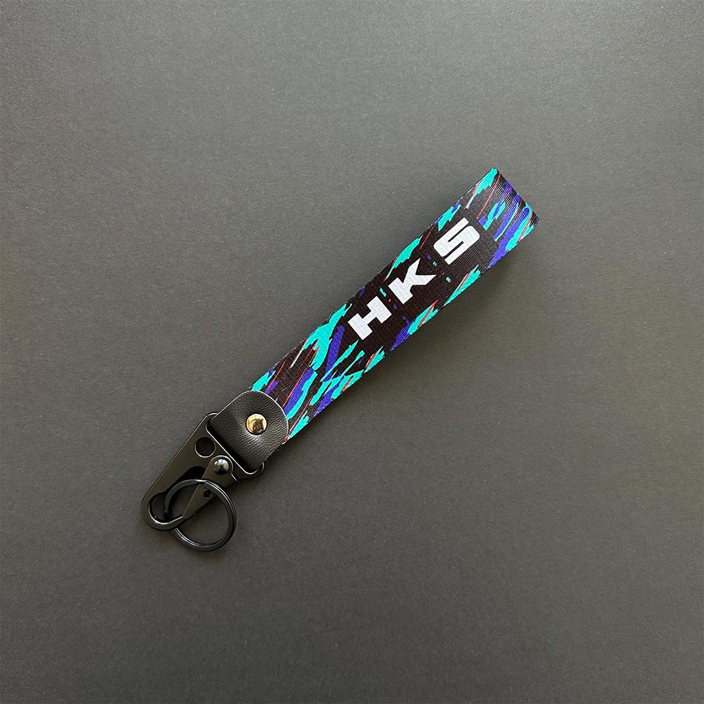 A flat lay HKS lanyard on a black background