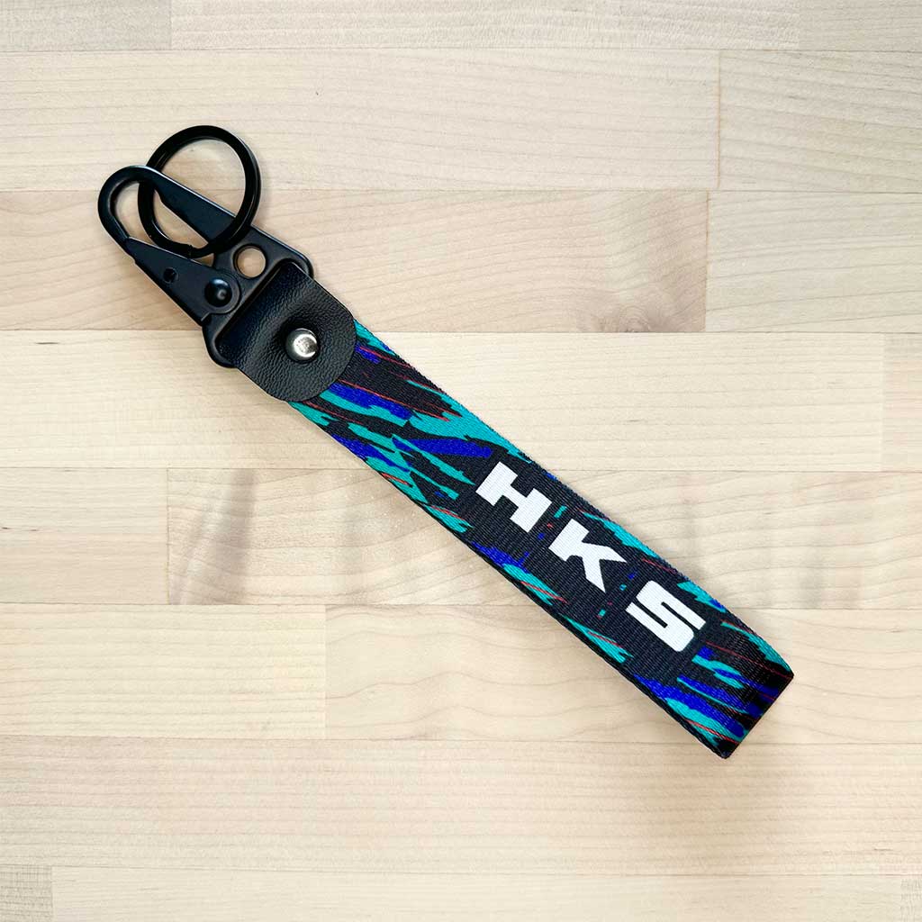 A flat lay HKS lanyard on a light-coloured wooden table
