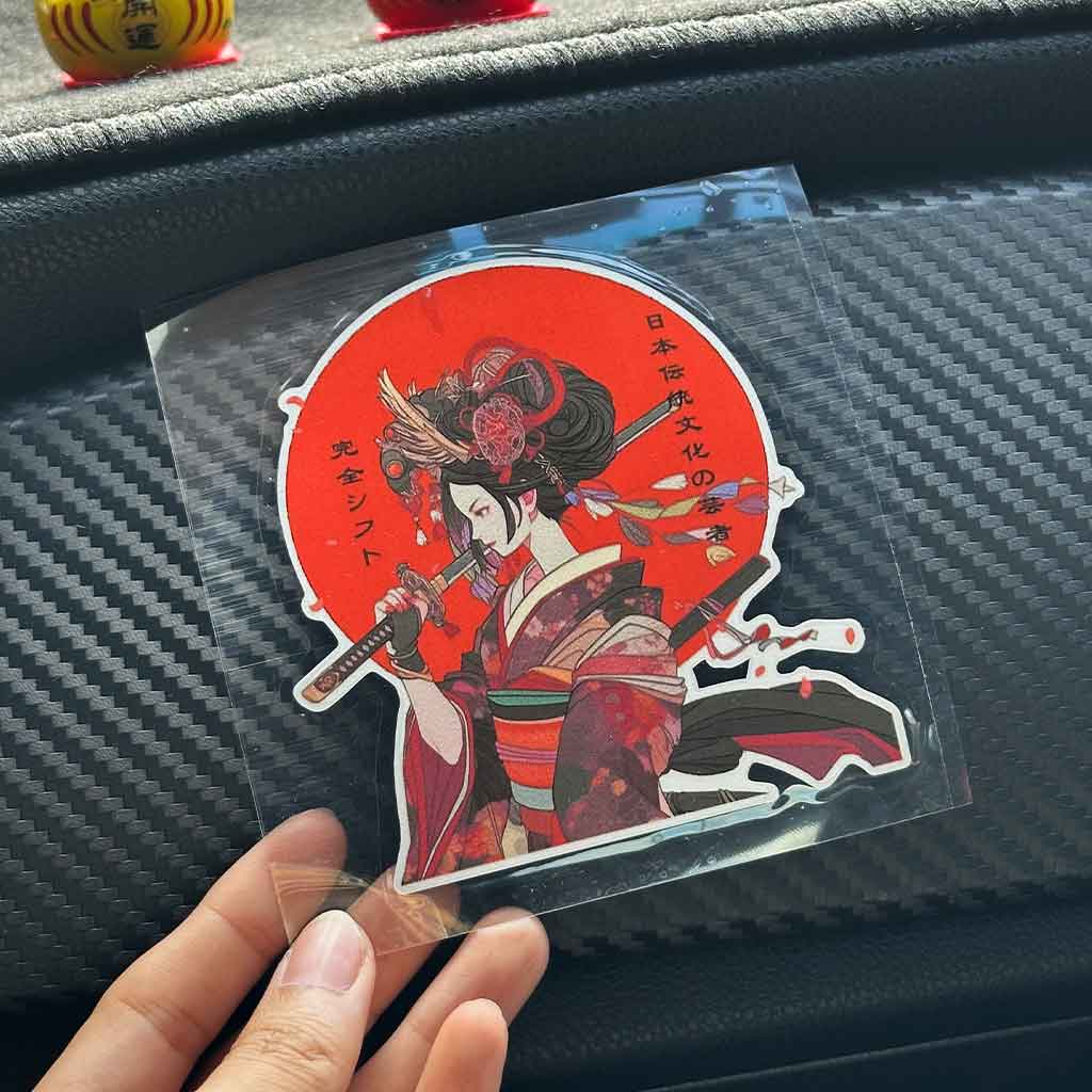 A hand holding a Geisha Lady JDM sticker