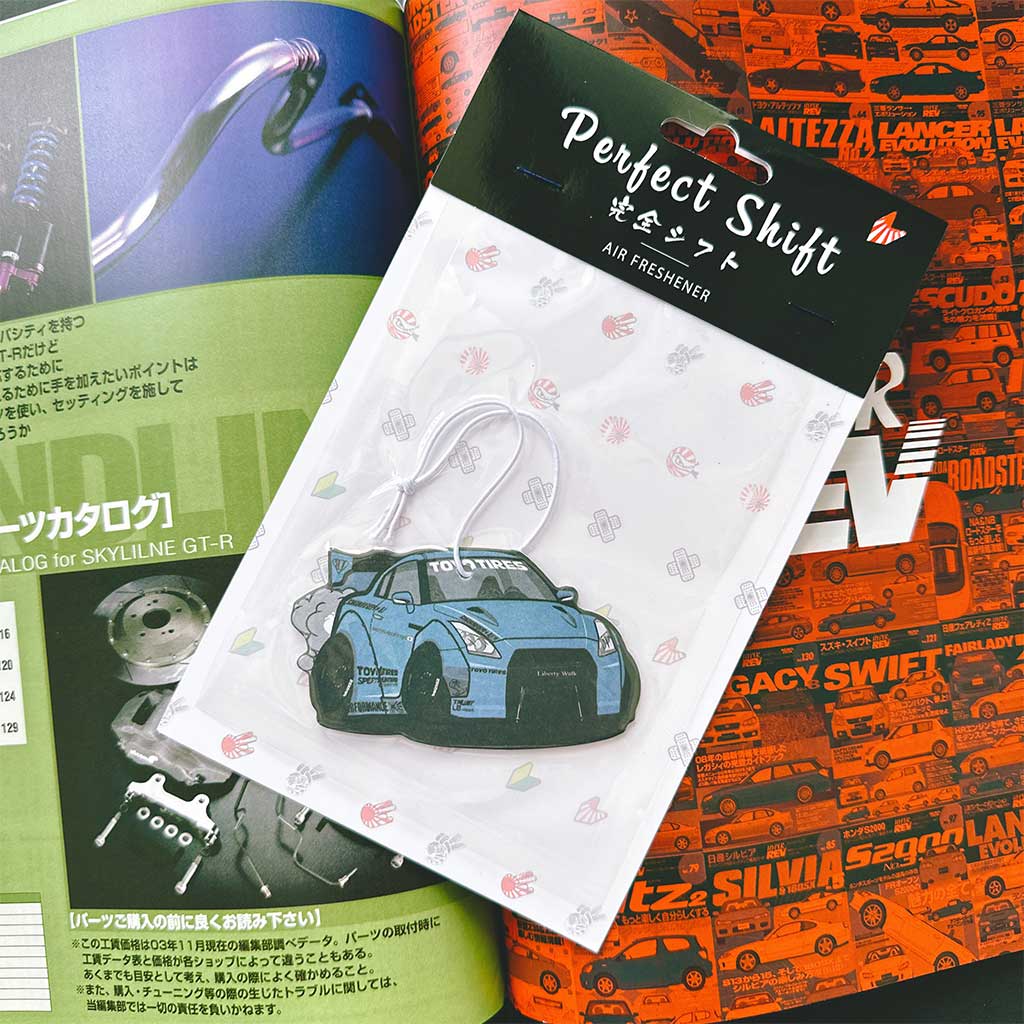 A JDM car air freshener themed GTR35 Toyo Tires flat laid on a Japanese magazine