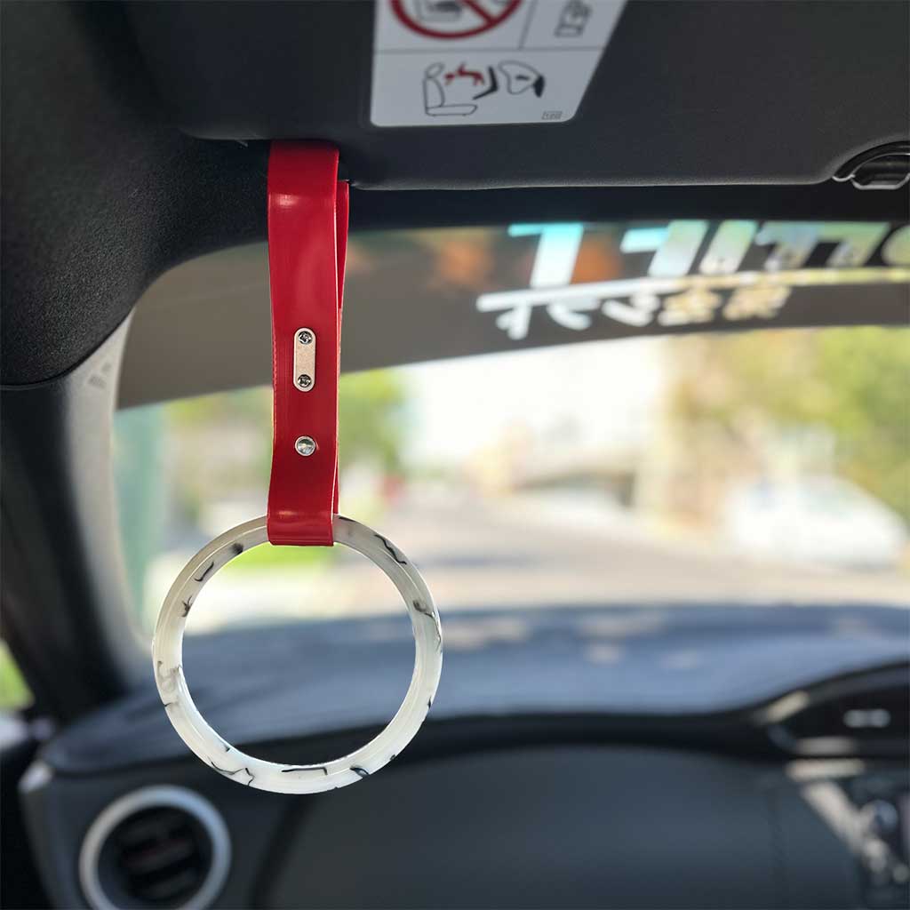 A marble tsurikawa with red strap hang in a white GT86