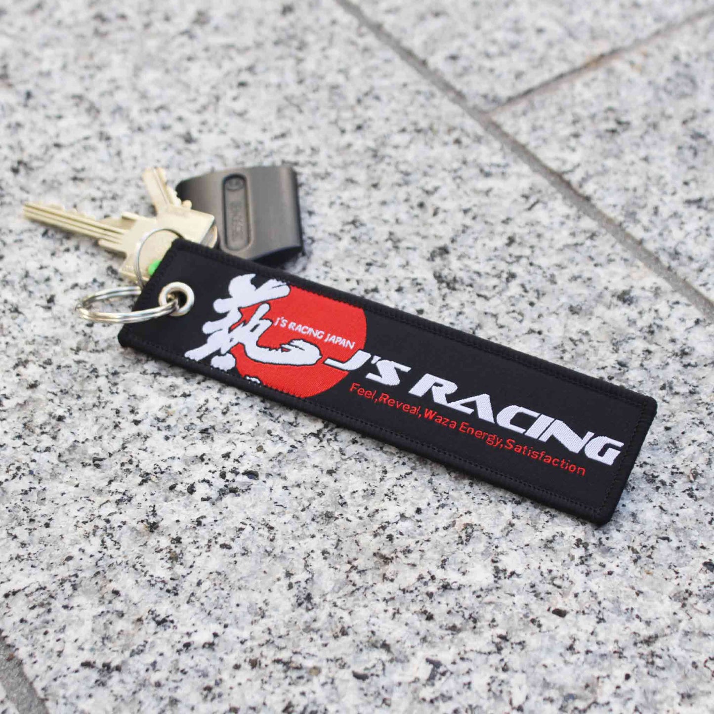 A black Honda J's racing jet tag on a marble floor