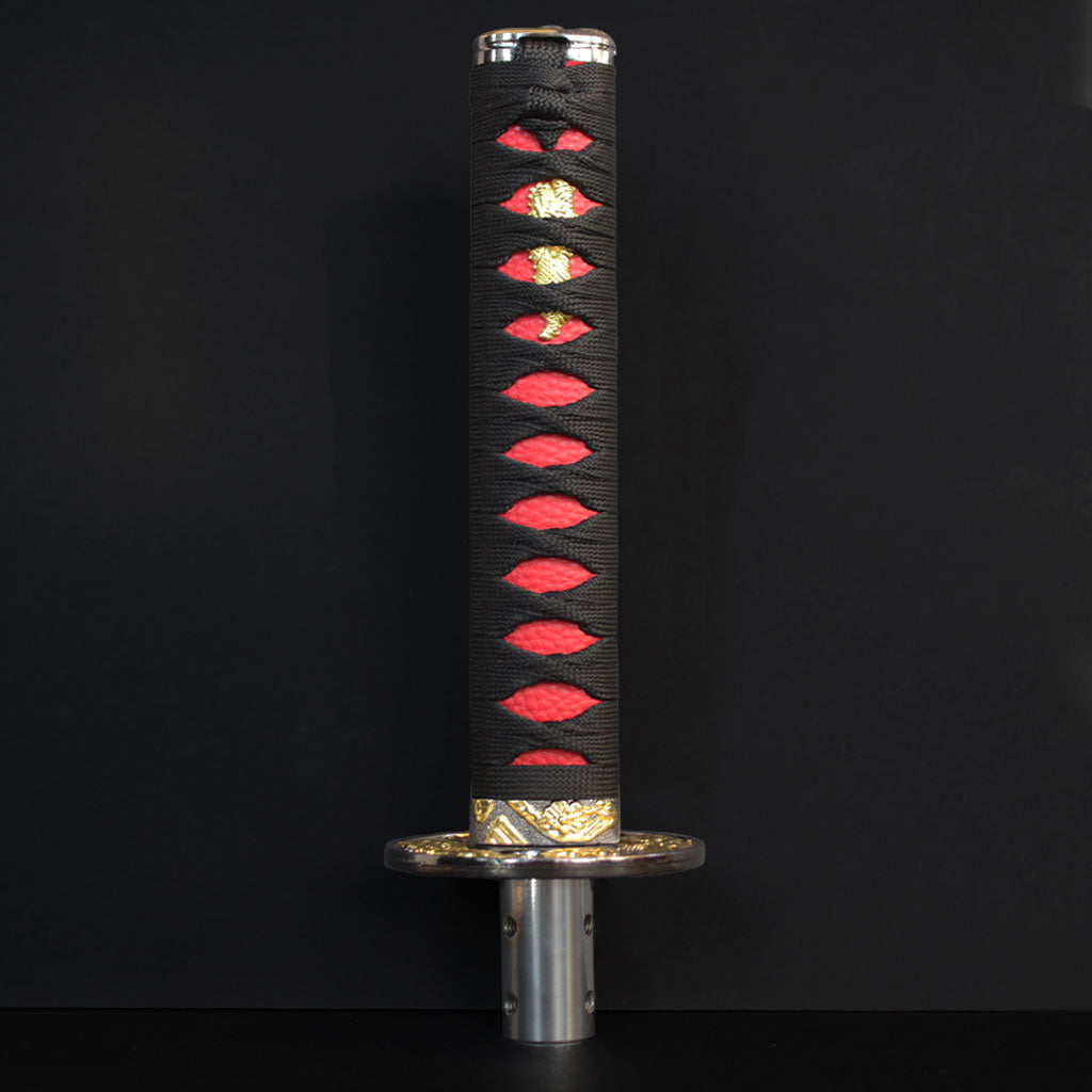 A black and red Katana shift knob standing in front of a black wall