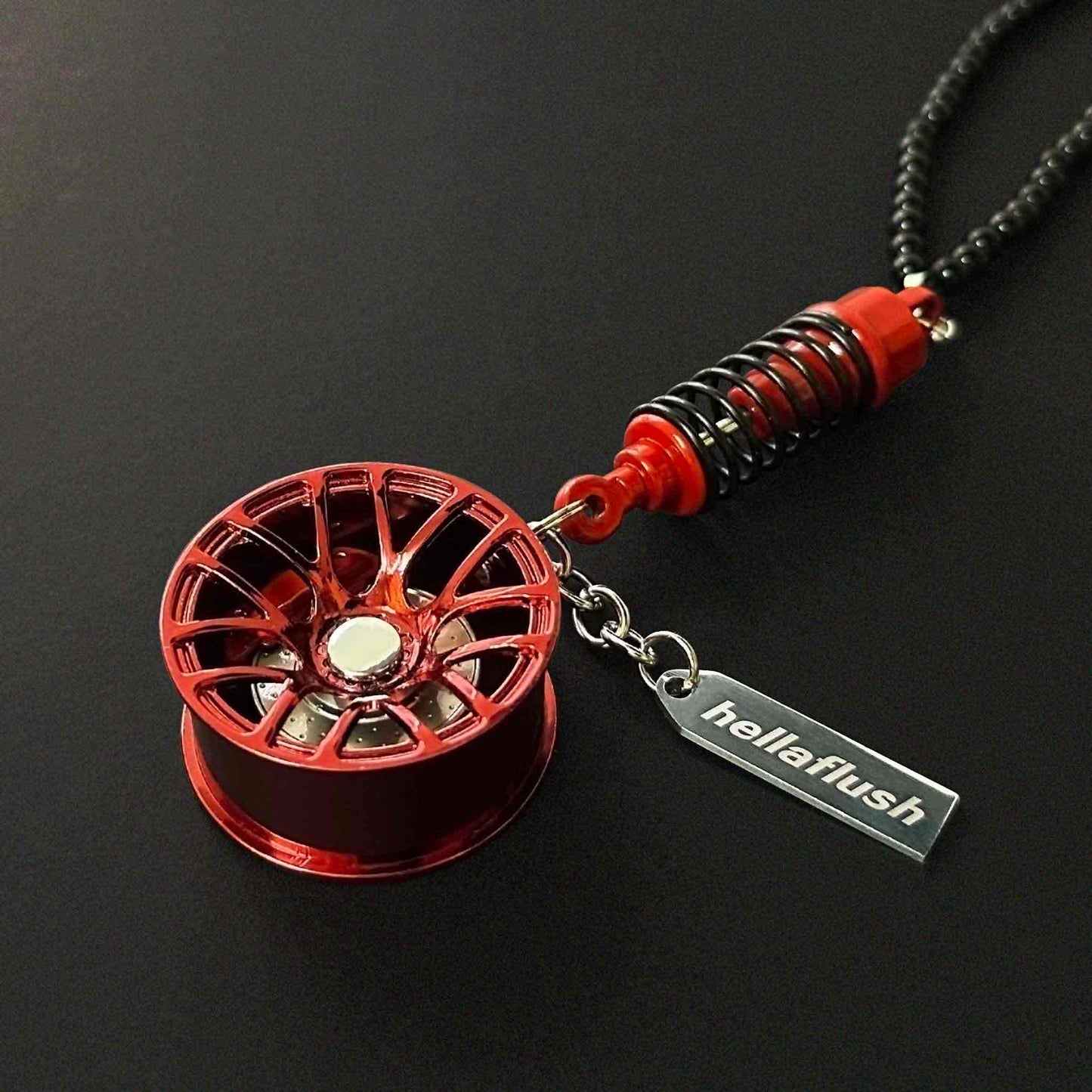 A red BBS style wheel decor flat laid on a black background