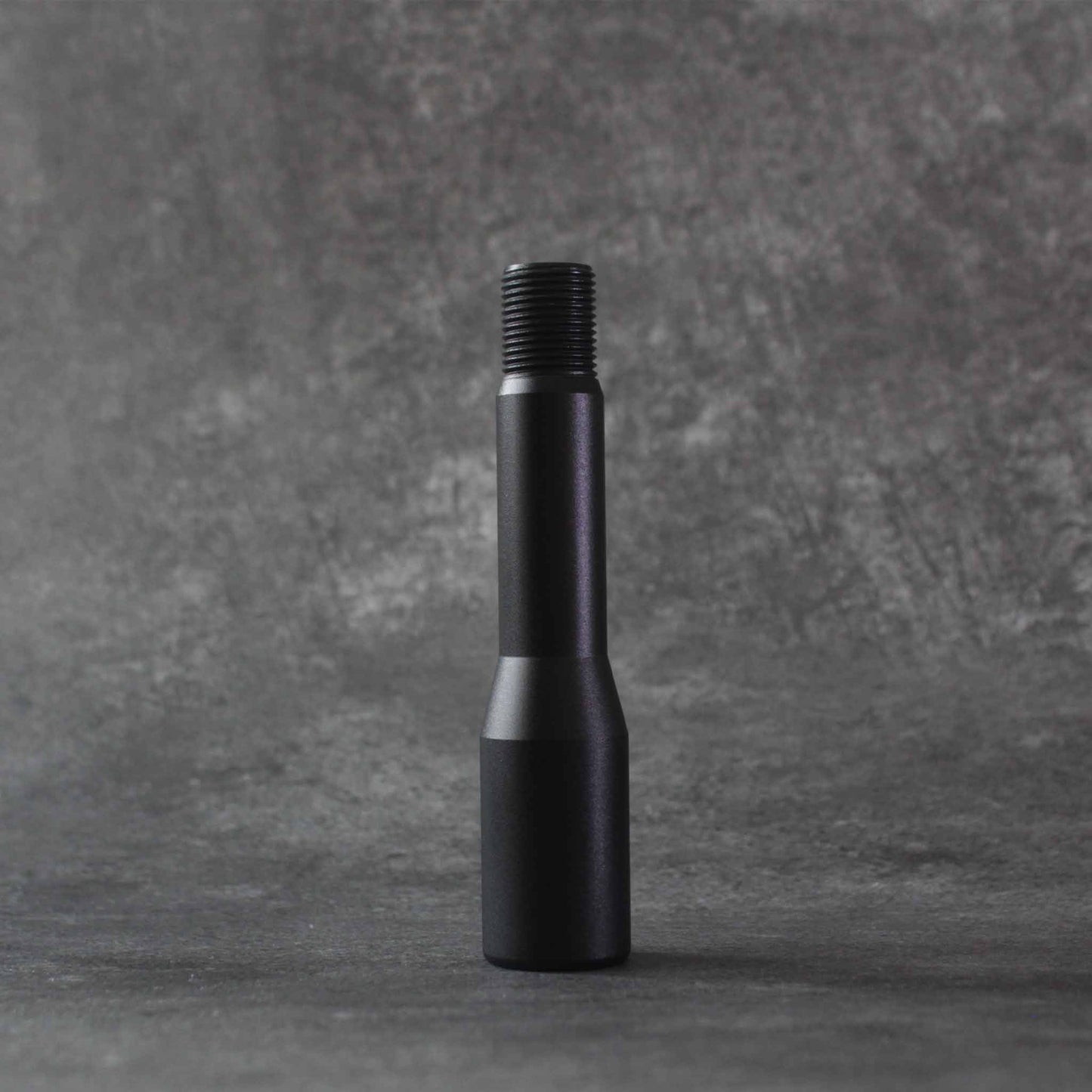 The shorter extension standing on a grey floor on a grey background