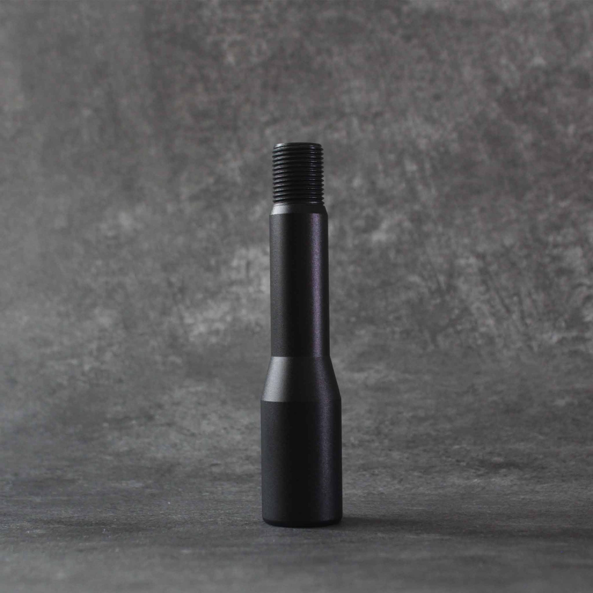 The shorter extension standing on a grey floor on a grey background