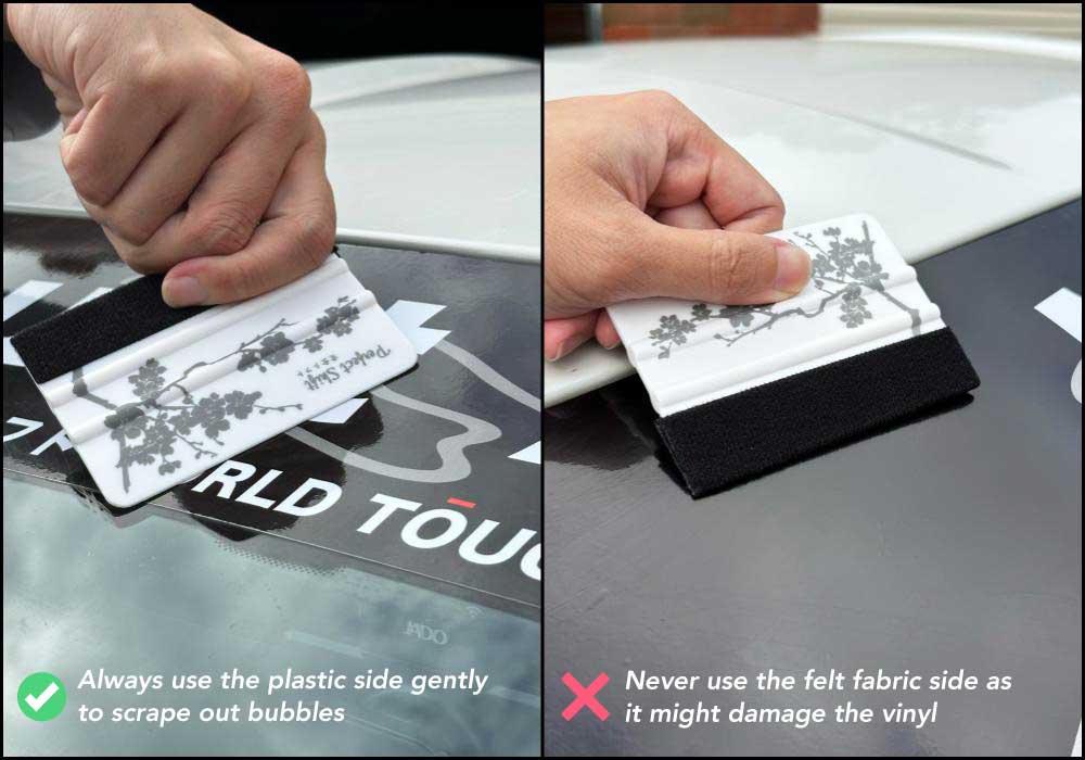 A hand holding a banner sticker application squeegees with cherry blossom pattern and Perfect Shift logo and provide guidance