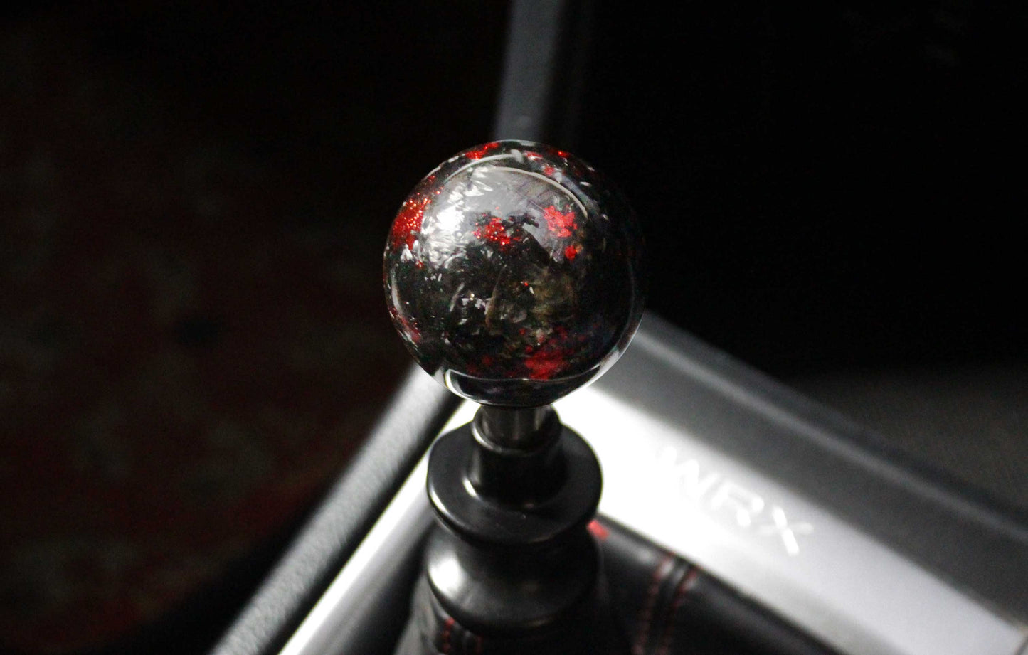 A black and red spherical carbon fibre shift knob installed in a 6-speed manual 2015 subaru wrx