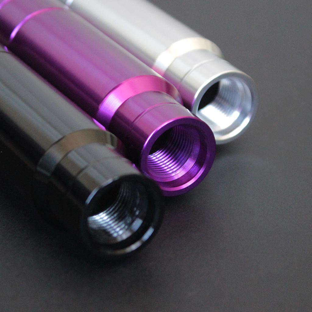 Threaded aftermarket shift knobs in different colours aesthetically flat laid on a black background