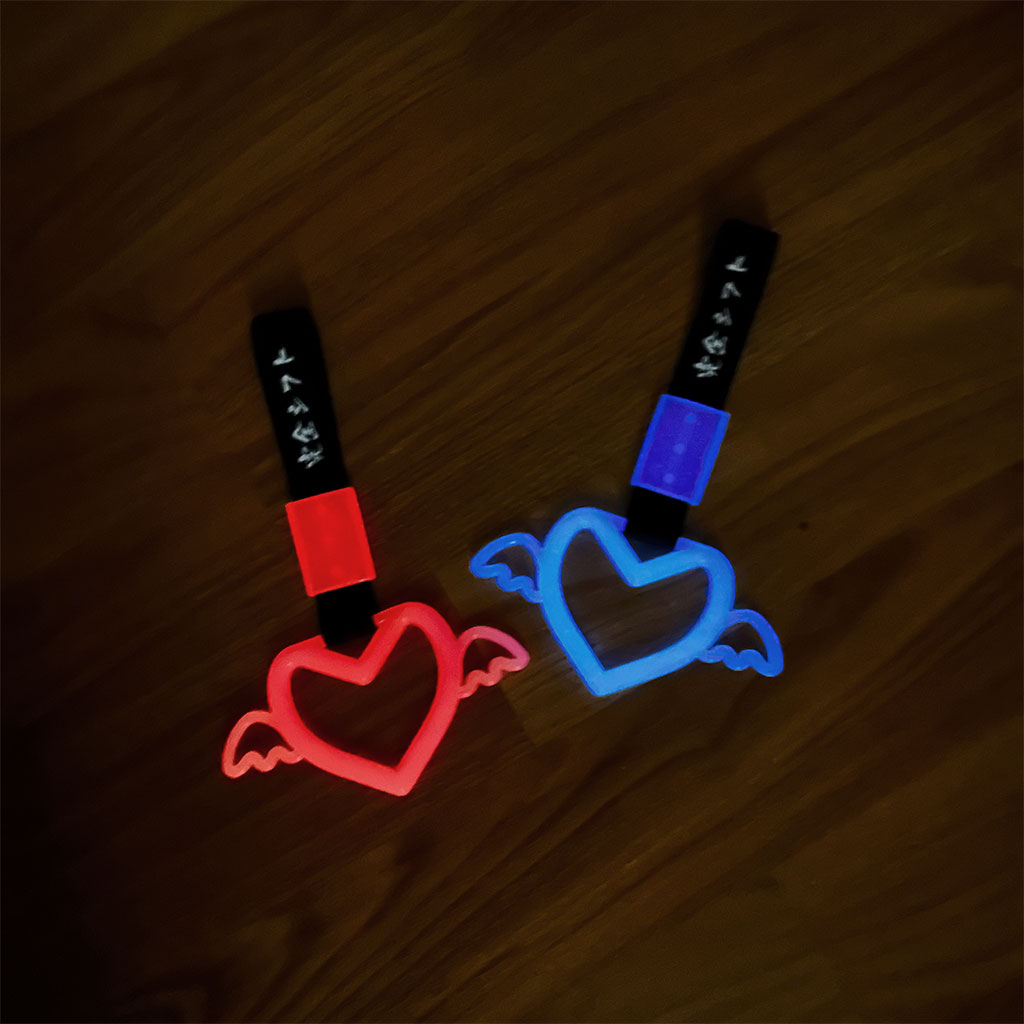 Two tsurikawa flat laid on the concrete ground and glowing red and blue