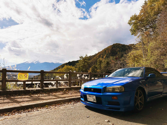 A Nissan Skyline GTR34 parked with the Mount Fuji as the background