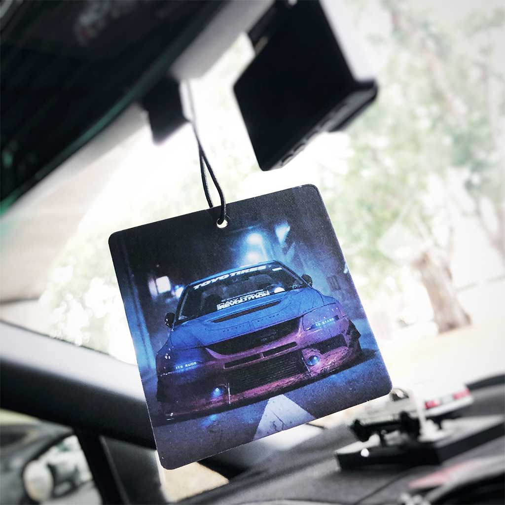 A Mitsubishi Evo air freshener hung in a car