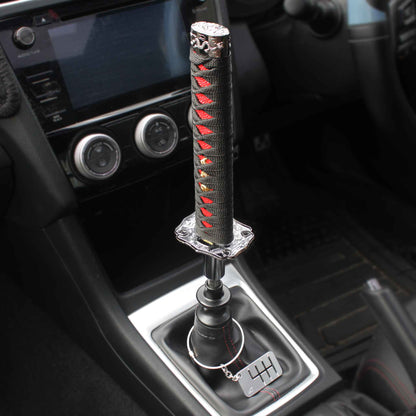 A black and red katana shift knob is installed on a manual WRX, and a six-speed dog-tag is hanging around the shift boot