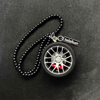 A black BBS wheel air-freshener placed on a black background
