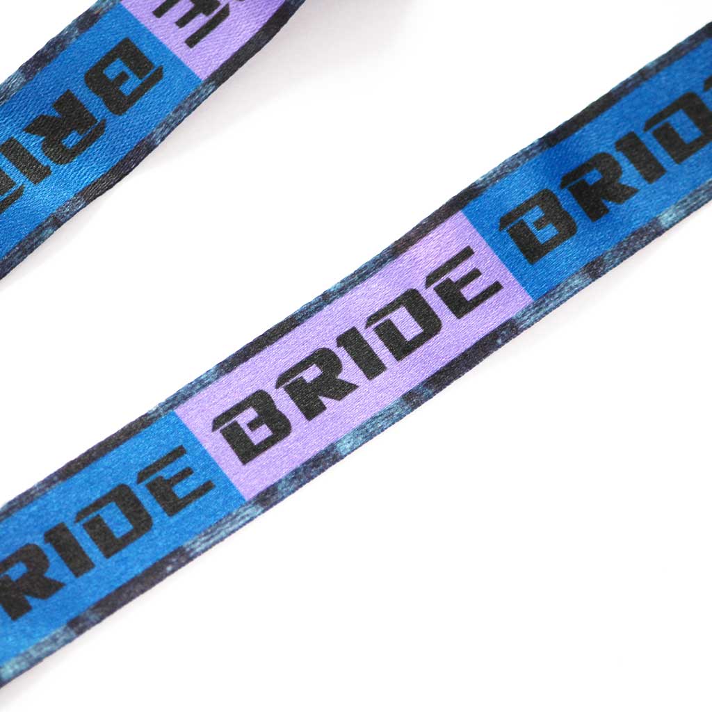 Close-up of the BRIDE logo on backgrounds with two colours: blue and purple.