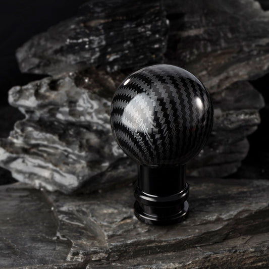 The Obsidian shift knob on a rock on a black background