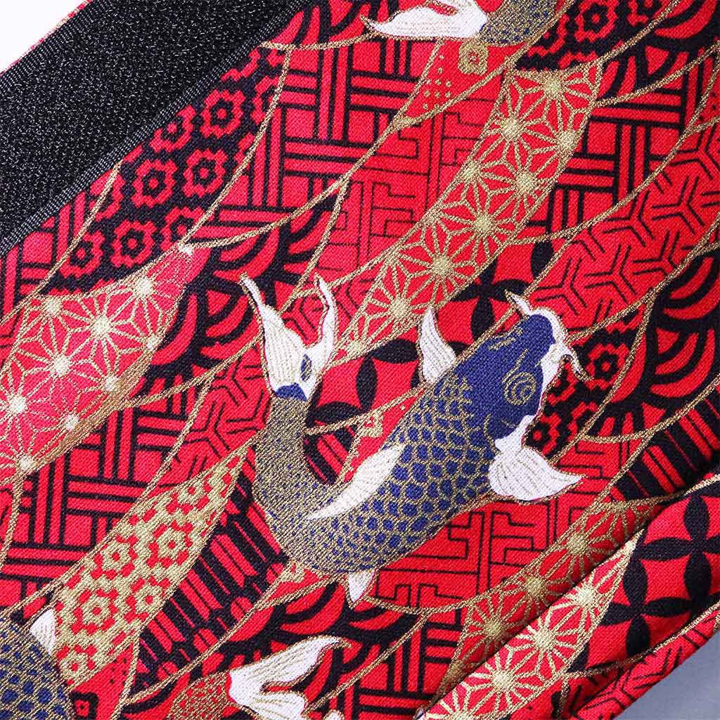 Close-up of the red koi fish pattern on a flat laid seat belt cover