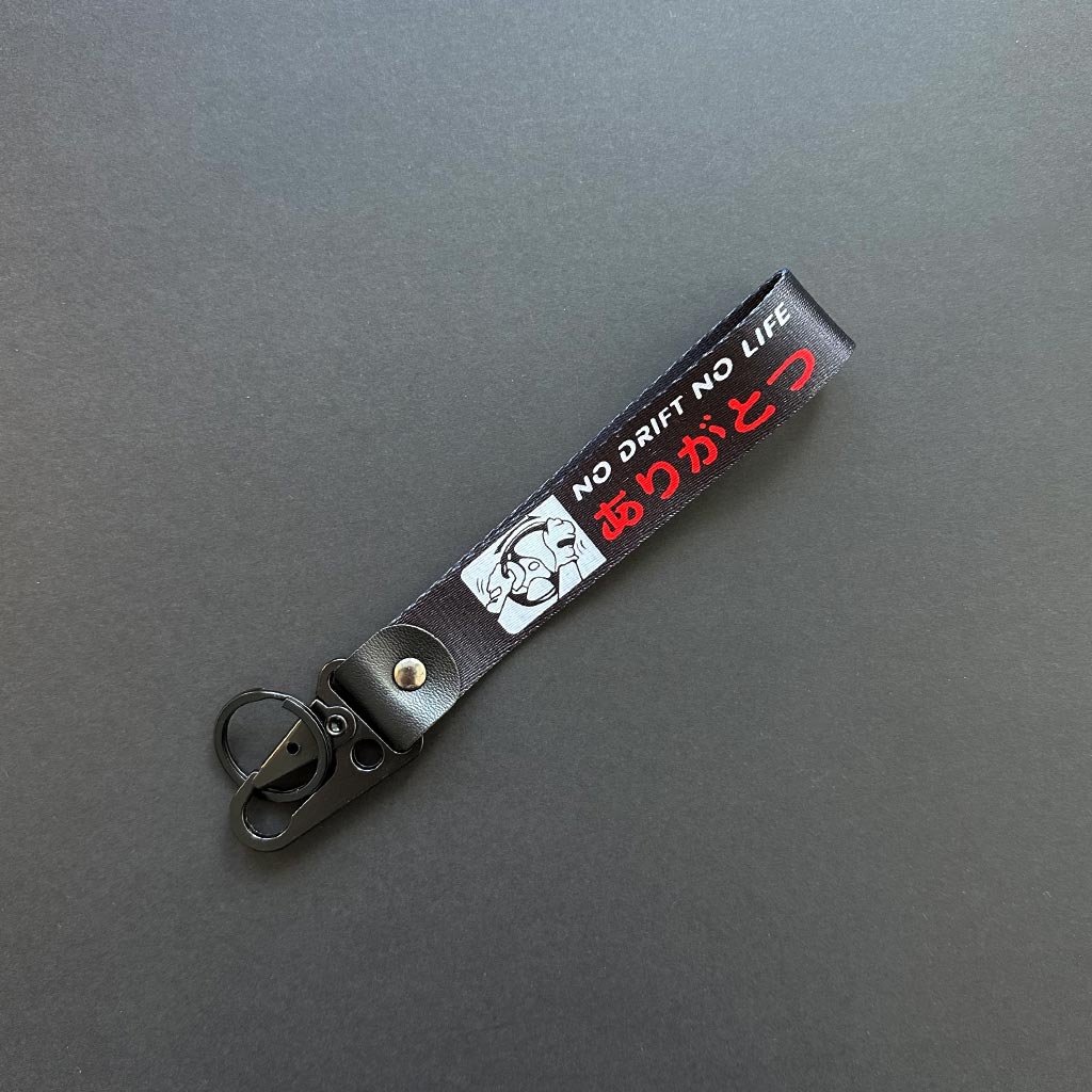 A flat lay No Drift No Life lanyard on a black background