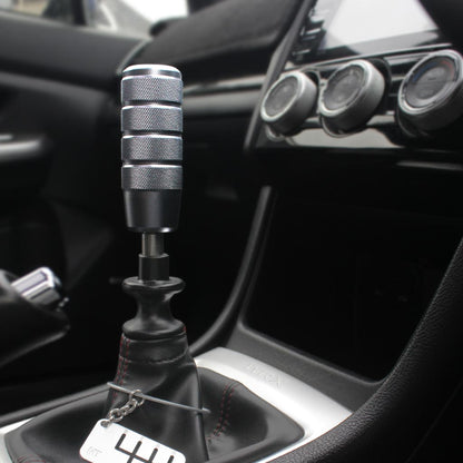 A grey Nagao is installed on a manual WRX, and a six-speed dog-tag hung on the shift boot