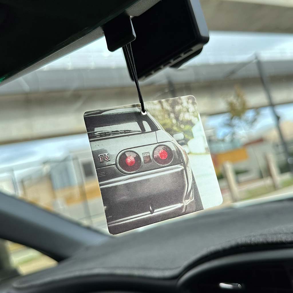 An air freshener with a pattern of the tail lights of a Skyline GTR R32 hung on a car's rearview mirror