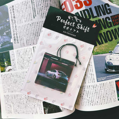 A JDM car air freshener themed Toyota 86 flat laid on a Japanese magazine