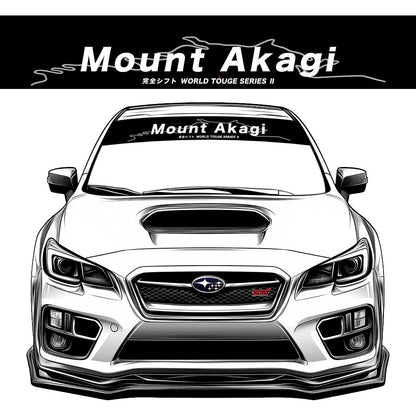 A black JDM car banner sticker with white character 'Mount Akagi' on a Subaru WRX STI front window