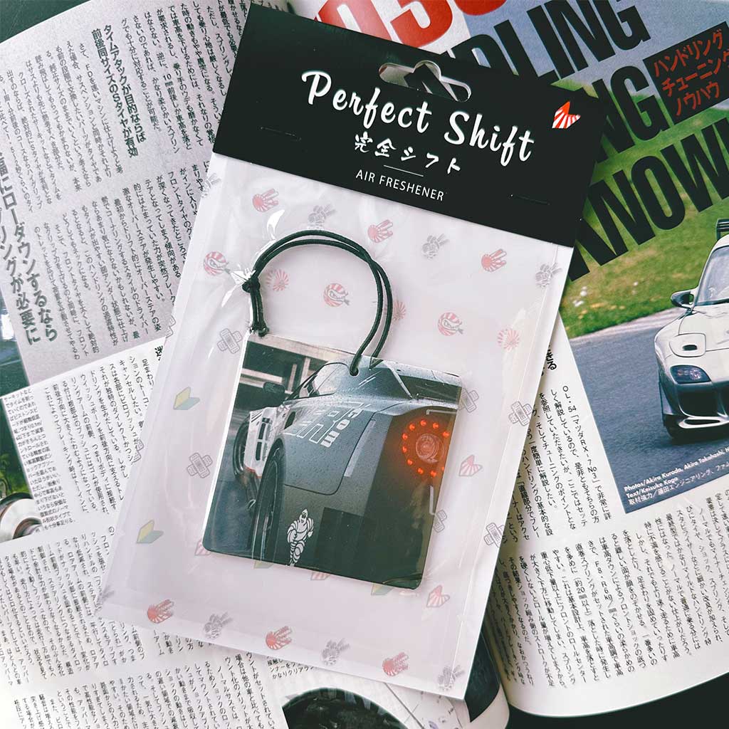 A JDM car air freshener themed Nissan Skyline GTR35 flat laid on a Japanese magazine