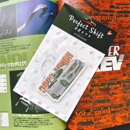 A JDM car air freshener themed Honda civic flat laid on a Japanese magazine