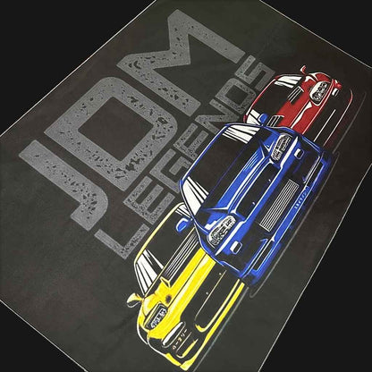 JDM Legends wall art on a black background, the wall art contains blue GTR, yellow RX7, and red Supra