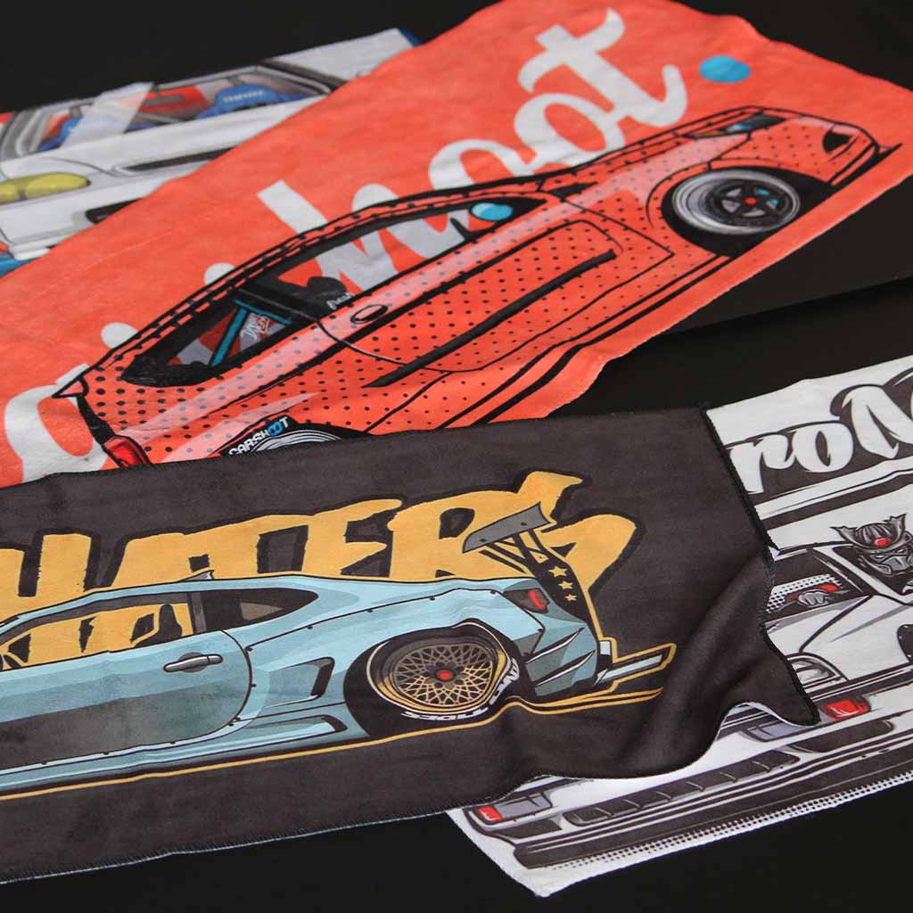 Four car towels with different designs flat laid on a black background