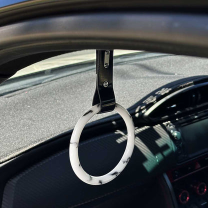 A marble tsurikawa with black strap hang in a blue WRX