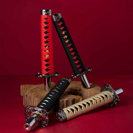 Four katana sword shift knobs are either standing or laying on a wooden object on a red background