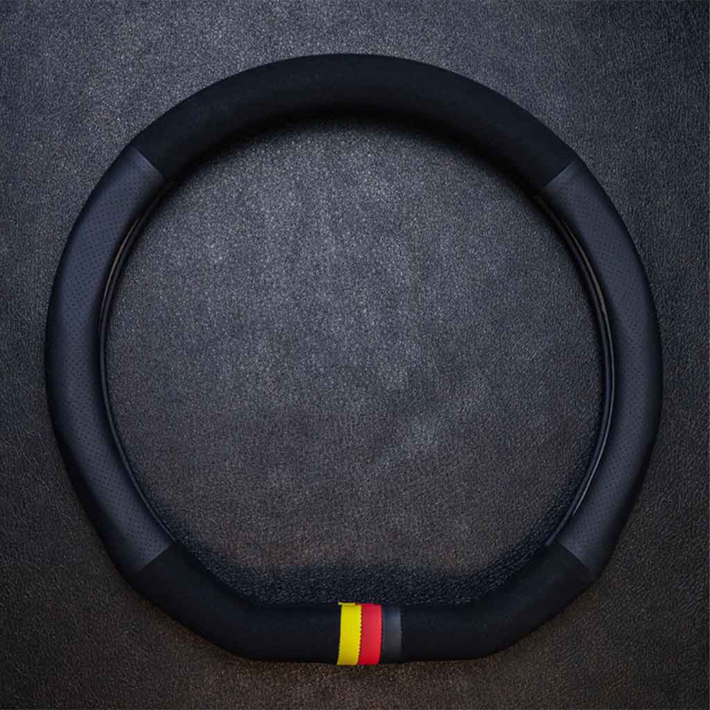 An all-black suede and leather steering wheel cover in D shape with three-coloured mark flat laid on a grey background