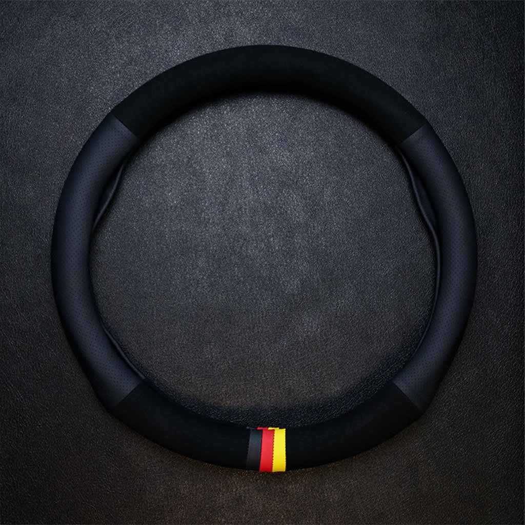 An all-black suede and leather steering wheel cover in O shape with three-coloured mark flat laid on a grey background