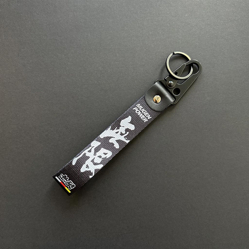 A flat lay black lanyard on a black background