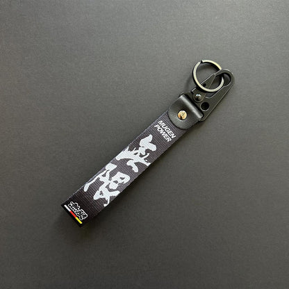 A flat lay black lanyard on a black background