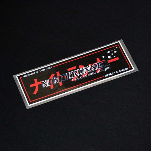 A Night Runner slap sticker flat laid on a black background