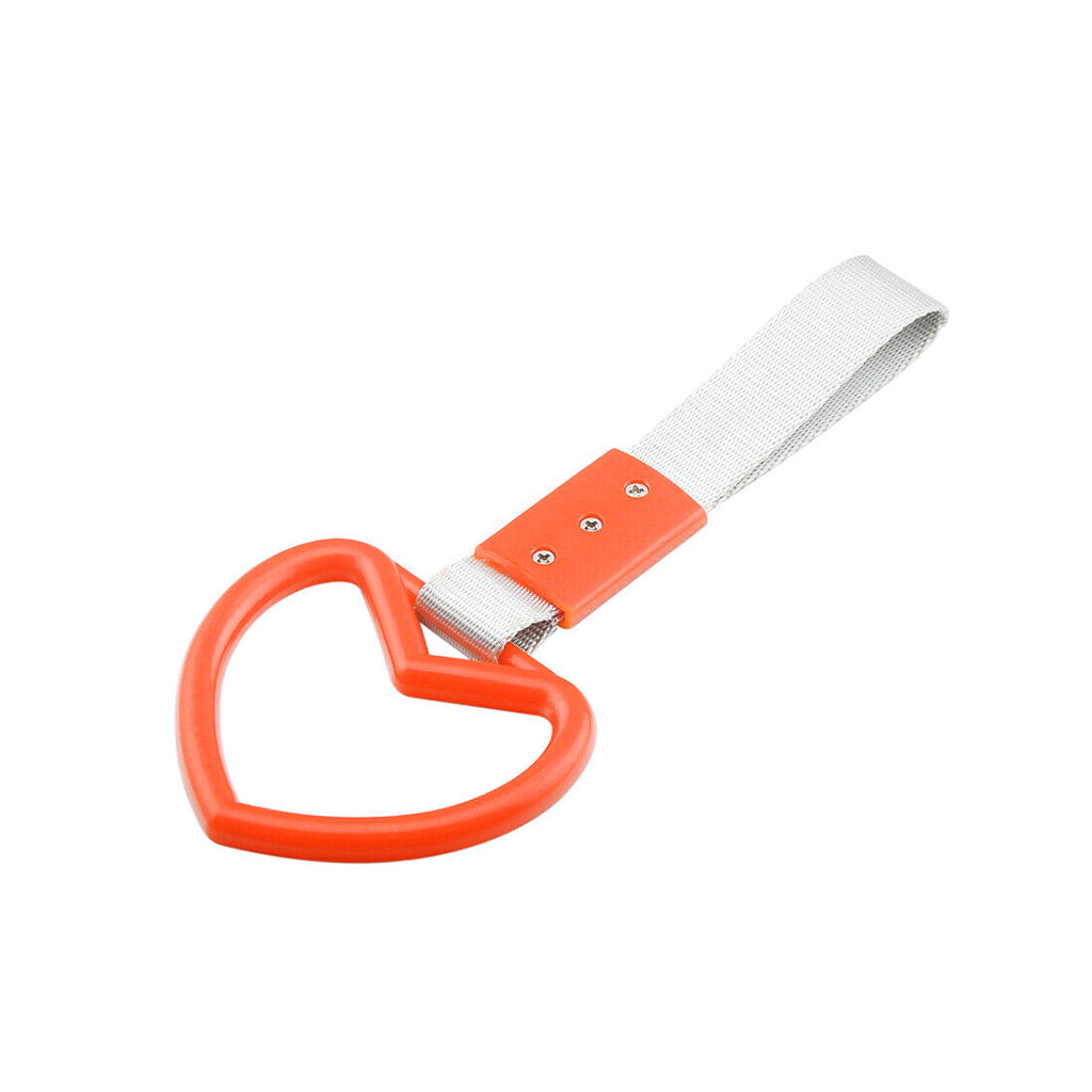 A orange heart tsurikawa with silver handle strap flat laid on a white background