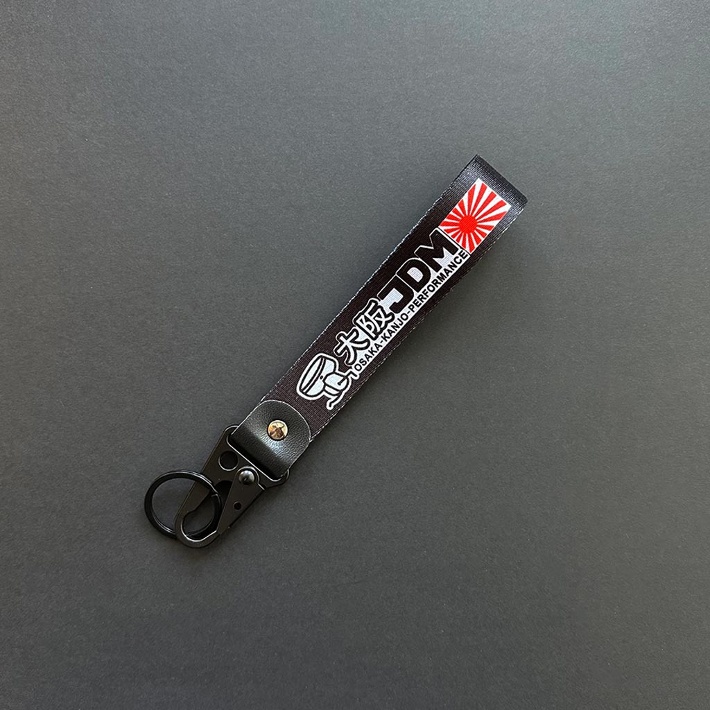 A flat lay Osaka lanyard on a black background