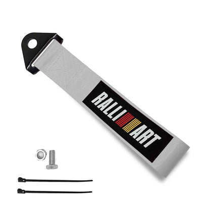 A silver ralli-art tow strap, a set of bolt and nut, and two zip ties on a white background