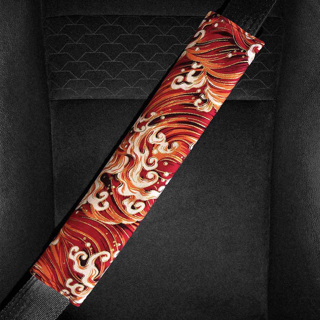 A red waves seat belt pad is installed in a car