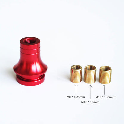 A red threaded boot retainer is standing upright on a white background with three aluminum adapters in different sizes beside it