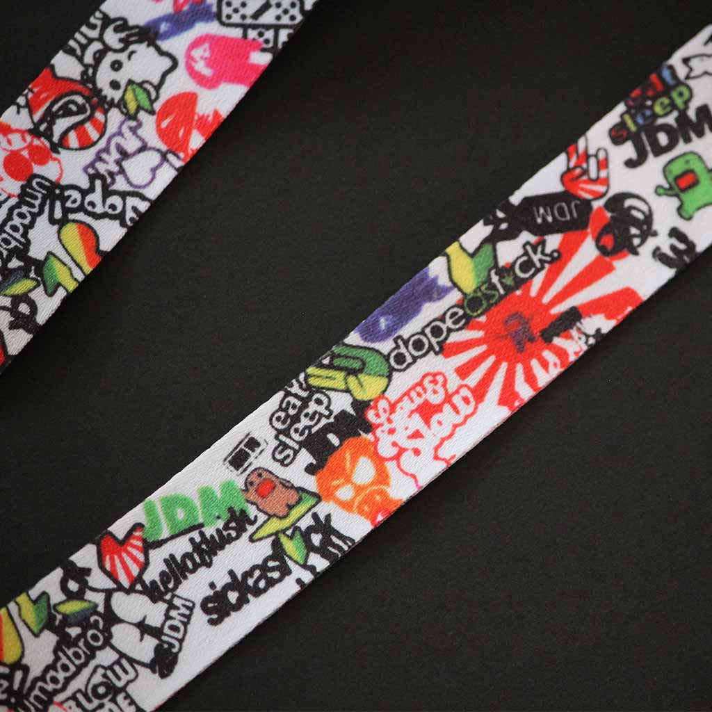 Close-up of the lanyard patterns including domo kun, hella flush, dope af, JDM fingers etc